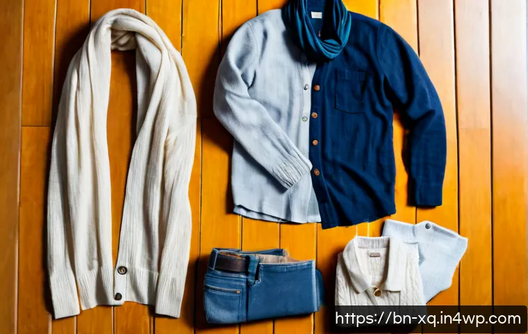 계절별 캡슐 옷장에 적합한 패브릭 소개 - Photorealistic overhead flat lay of a seasonal capsule wardrobe on a warm wooden floor, neatly arran...